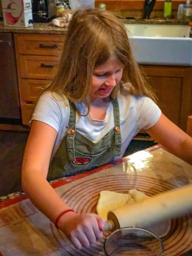 Nora in a battle of wills with the pizza dough.