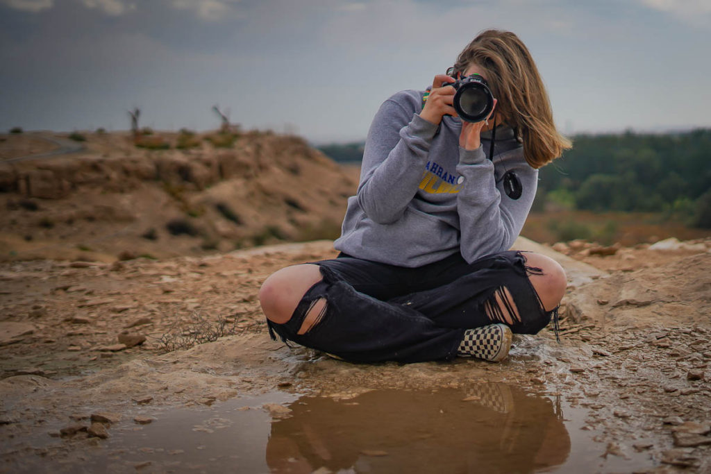 In front of a puddle.  Check out the next gallery for what she was taking a picture of.