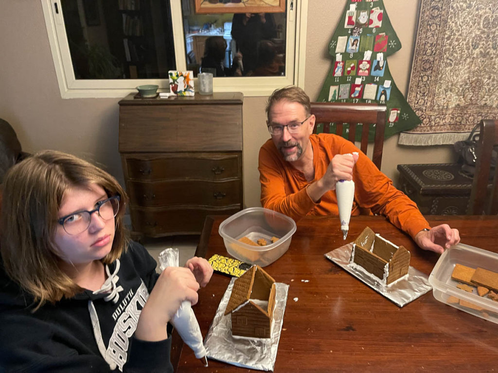 Noah could not be more excited to be building the gingerbread houses.  Dad was trying to get a smile but failed.
