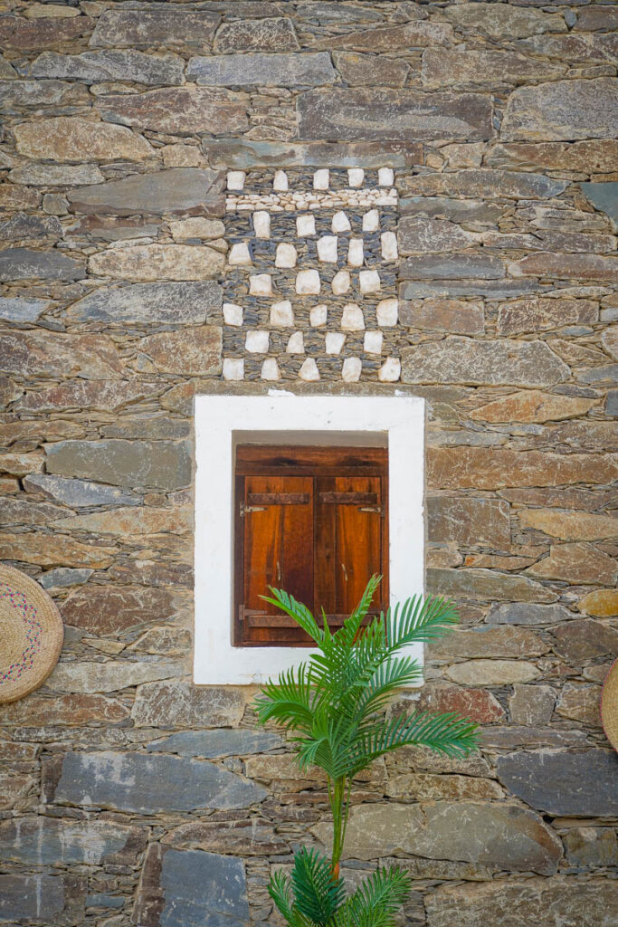 A window at Riyal Al Umaa.  The stonework pattern above the window is the architect's signature