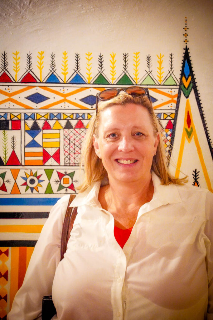 Crystal posing with some Al Qat artwork - the traditional wall painting done inside homes