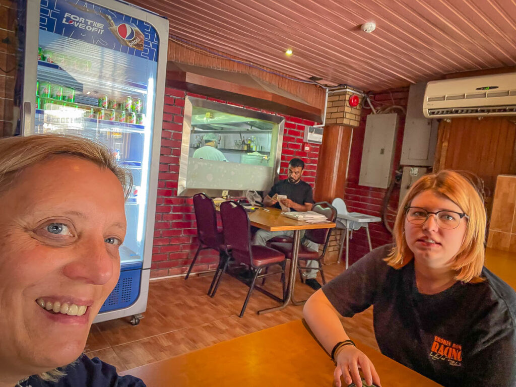 Crystal and Noah waiting to collect takeout at the always popular Phuket restaurant in Khober